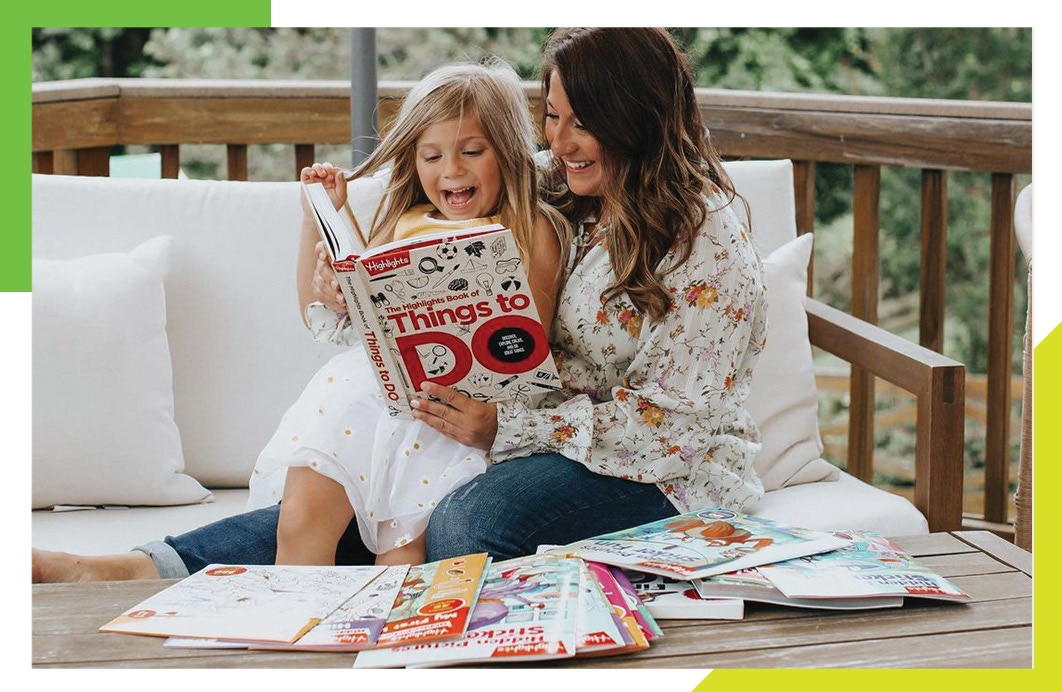 Grandmother and Granddaughter reading Highlights magazine together