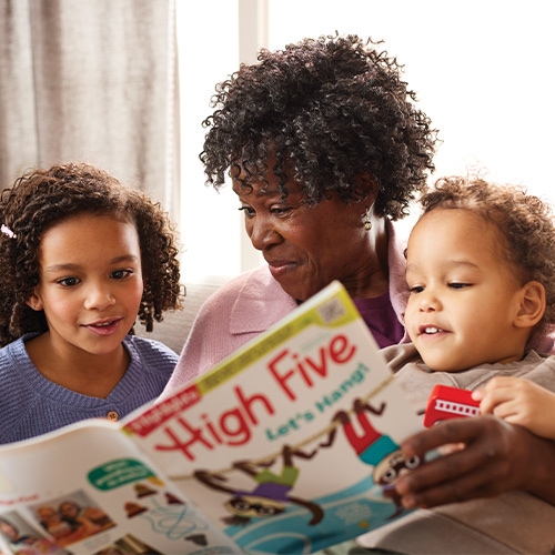 A grown-up and 2 children reading High Five magazine.
